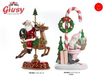 Giostra In Resina Di Babbo Natale Che Cavalca Una Renna H.46 Cm